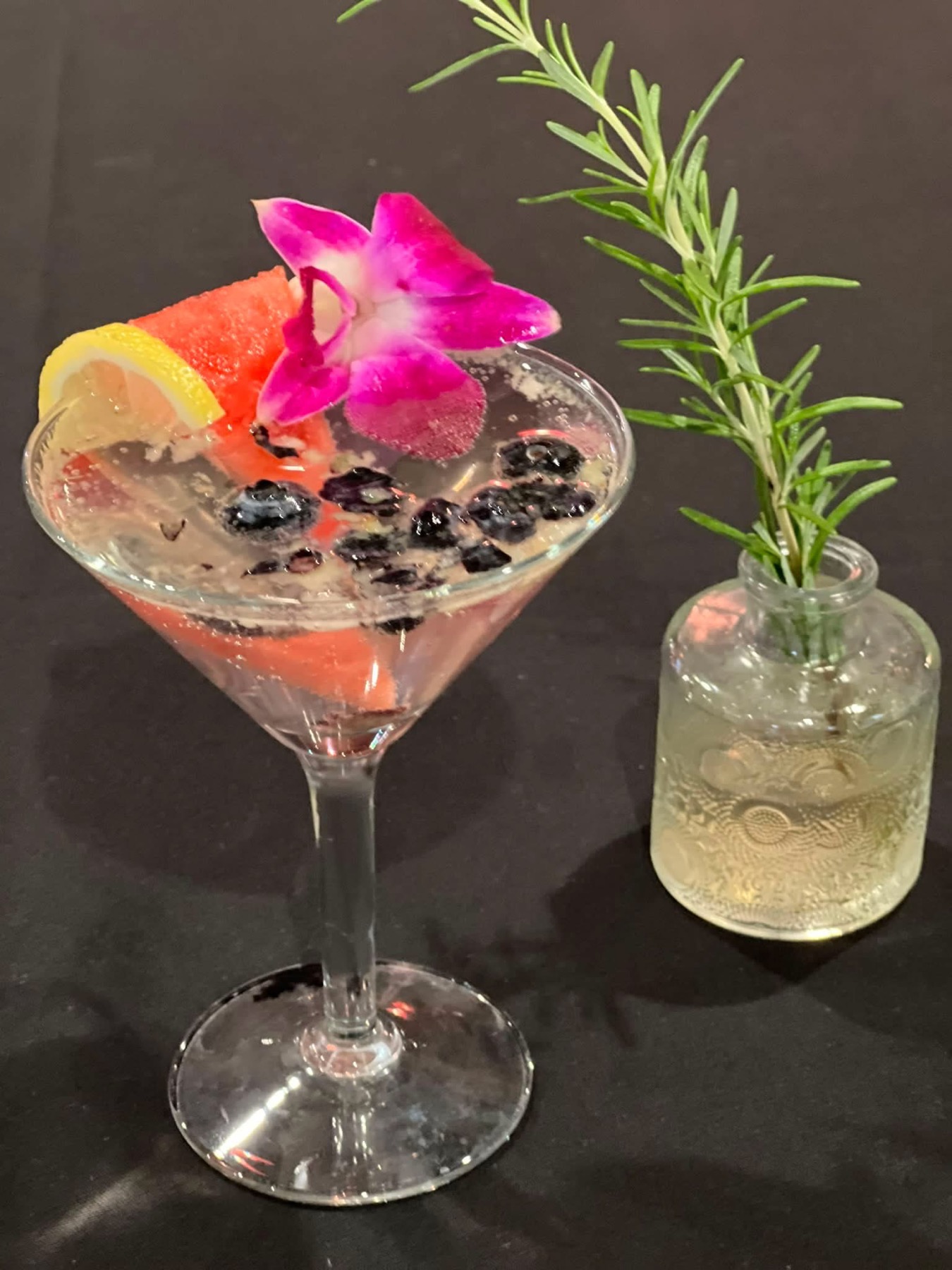 House cocktail finished with a purple orchid
