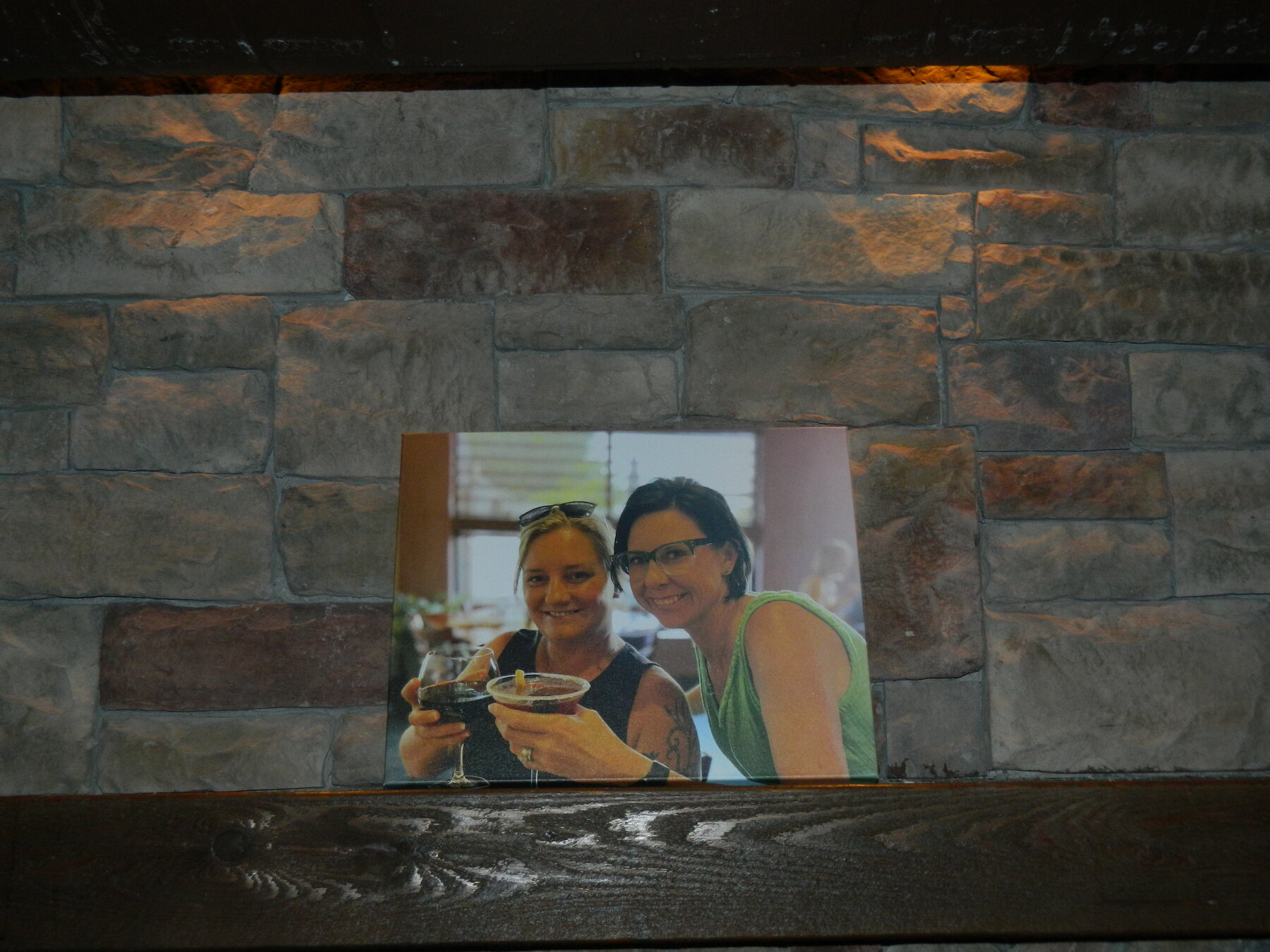 A personal photograph displayed above the stone fireplace