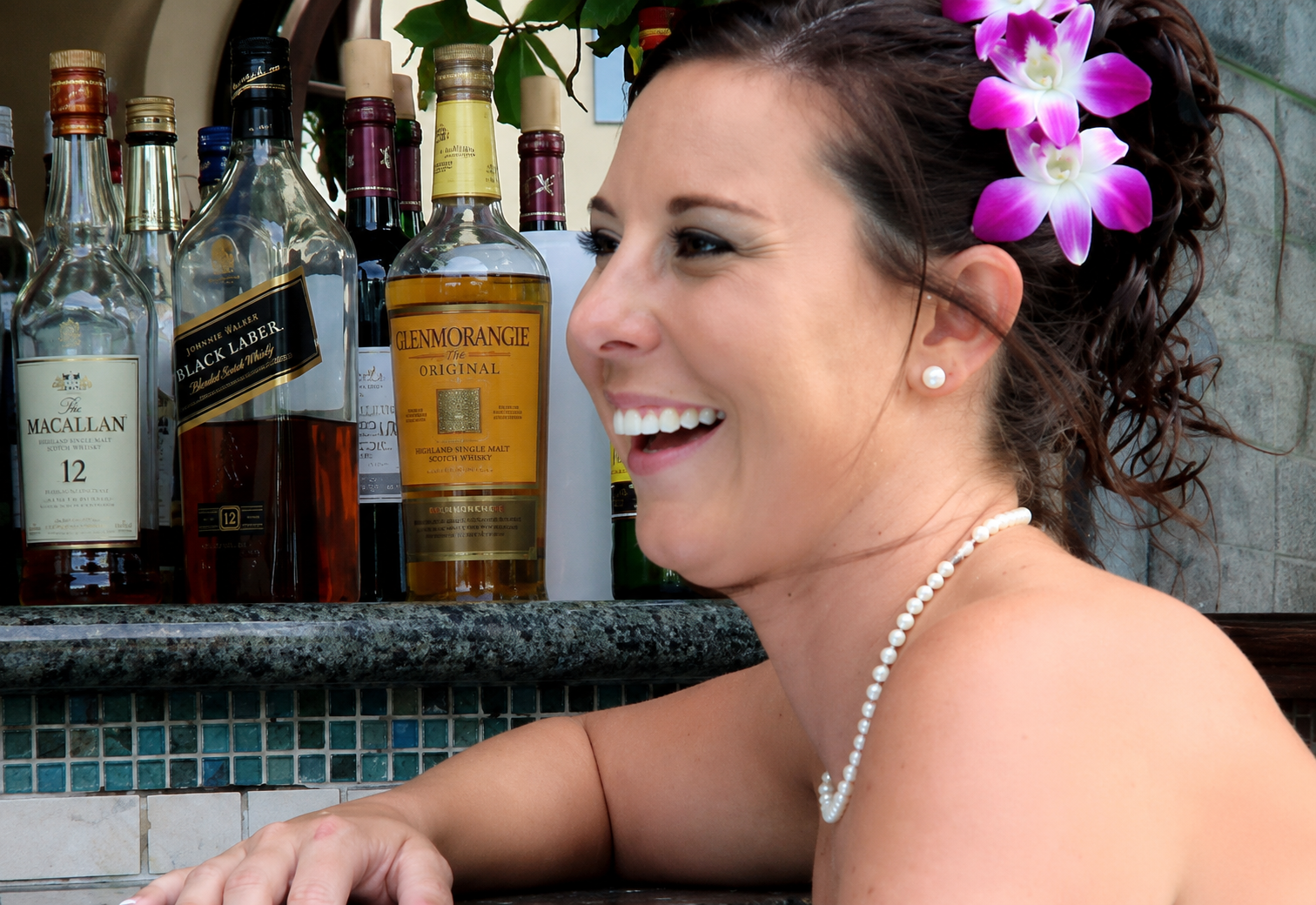 Karry Ward smiling with a purple orchid in her hair
